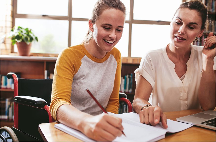 Tutor helping student at school.